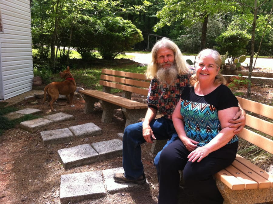 Don and Cindy Bradley, caretakers at the Palestine Gardens, pose for a portrait on April 22 in Lucedale, Miss.