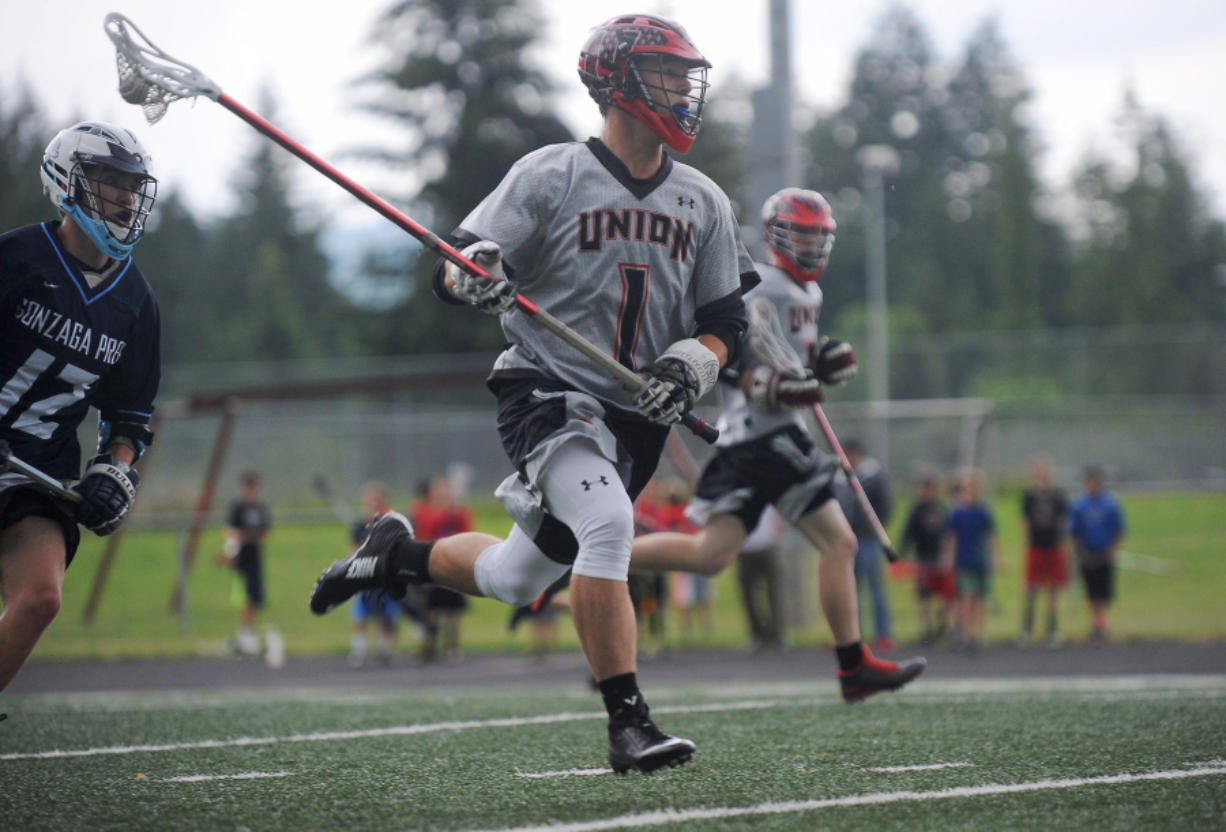 Union&#039;s Hunter Cofer sprints with the ball as he plays in a state semifinal lacrosse match against Gonzaga Prep in Camas High School&#039;s Cardon Field Wednesday May 25, 2016.
