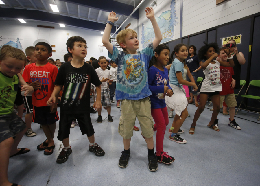 Mill Plain Elementary School students dance Friday at a victory celebration in the gym after winning the local Trex Plastic Film Recycling Challenge. They collected nearly 2,000 pounds of plastic, which will be recycled into Trex lumber.