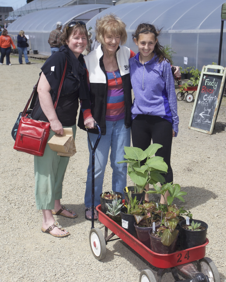 Shannon Atchison of Tillamook, Ore., from left, Joyce Hollingsworth of Vancouver and Clare Atchison, 14, of Tillamook pose Sunday for a Mother&#039;s Day photo at a plant sale at the 78th Street Heritage Farm. The Mother&#039;s Day-weekend sale is a fundraiser for the Master Gardener Foundation.
