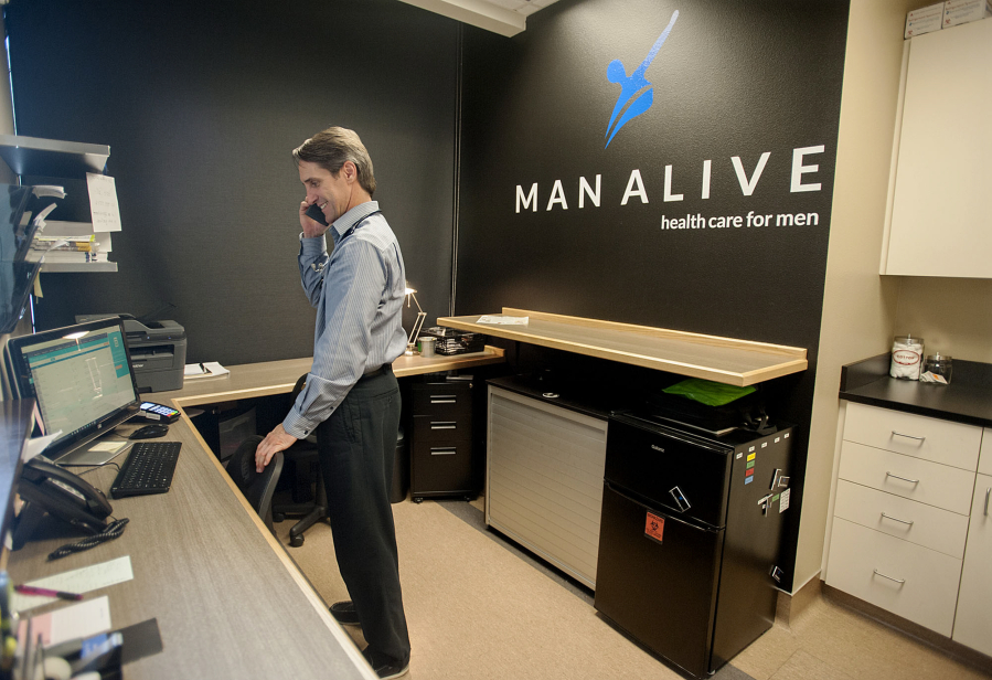 Dave McQuivey helps a caller on the phone Wednesday afternoon at Man Alive Clinic.