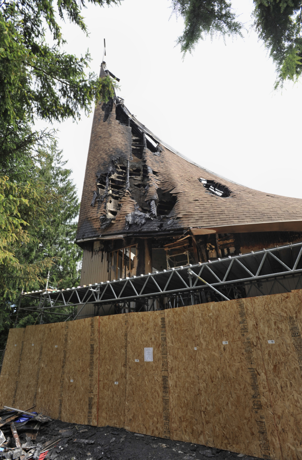 Damaged sections of the First Congregational United Church of Christ were boarded up Sunday morning. The building was damaged in a suspected arson Wednesday.