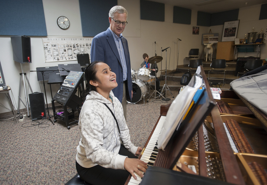 Student Oryann Fitim, 16, foreground, plays for Superintendent Dean Stenehjem on Monday afternoon at the Washington State School for the Blind. He is retiring at the end of the school year after 26 years at the helm of the state school.