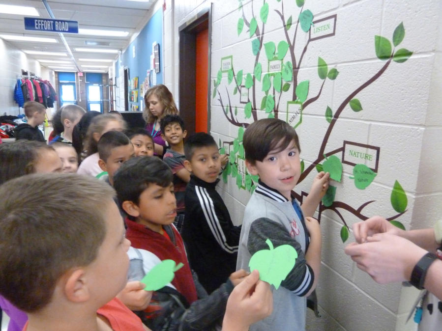 Image: Mallory Schumacher&#039;s third-grade class at Image Elementary School place leaves on the school&#039;s kindness tree.