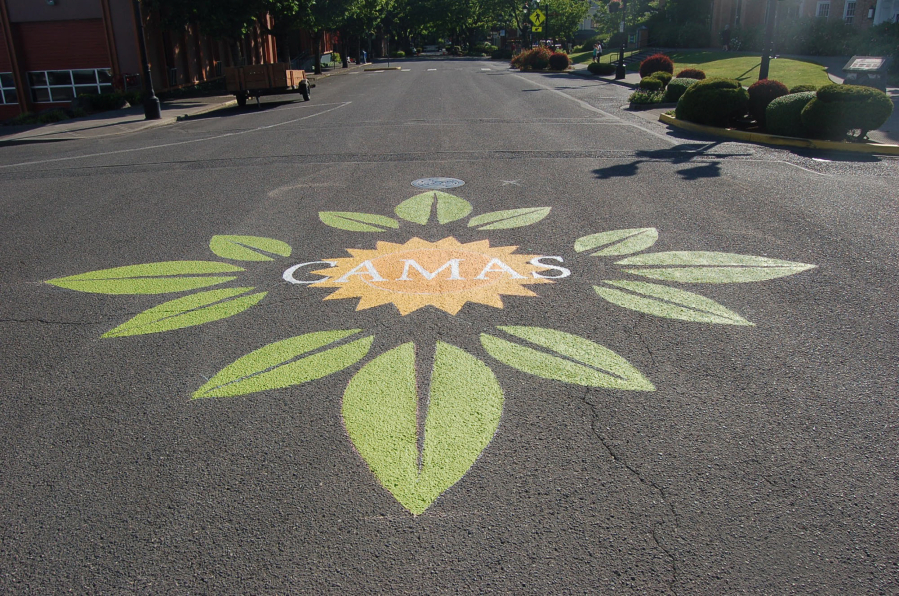 Camas: Camas High School students and members of the Downtown Camas Association painted a street emblem at the bordering streets of the farmers market that was designed by Brianna Cloutier, a member of Camas&#039; Integrated Arts and Academics program.
