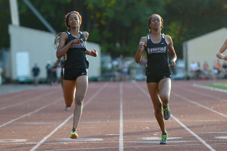 Sisters Jai&#039;Lyn, left, and Dai&#039;Lyn Merriweather finish second and first, respectively, in the women&#039;s 200 meter race during the final day of the Greater St. Helens 4A district championship track meet at McKenzie Stadium in Vancouver on Friday, May 13, 2016.