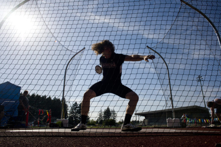 Union senior Bailey King hurls a discus during the final day of the Greater St. Helens 4A district championship track meet at McKenzie Stadium in Vancouver on Friday, May 13, 2016.