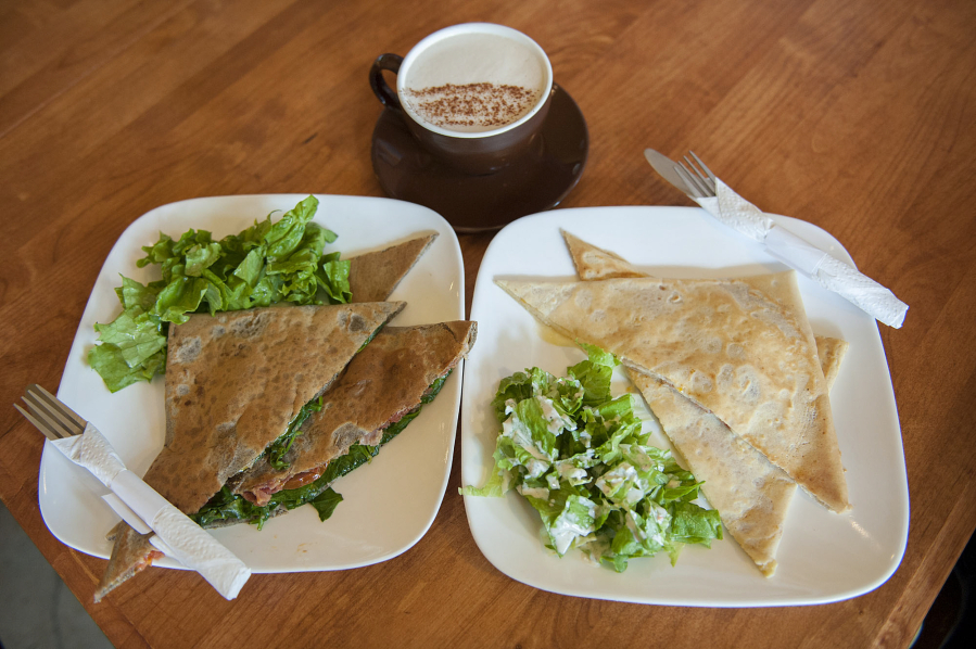 A bacon, spinach and tomato crepe, left, and a French club crepe, right, are served May 4 with a Dragonfly Chai at Mon Ami restaurant in Vancouver&#039;s Uptown Village.