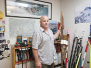 Surveyor Dan Renton holds a &quot;bearing tree scribe&quot; in his Vancouver office Tuesday.