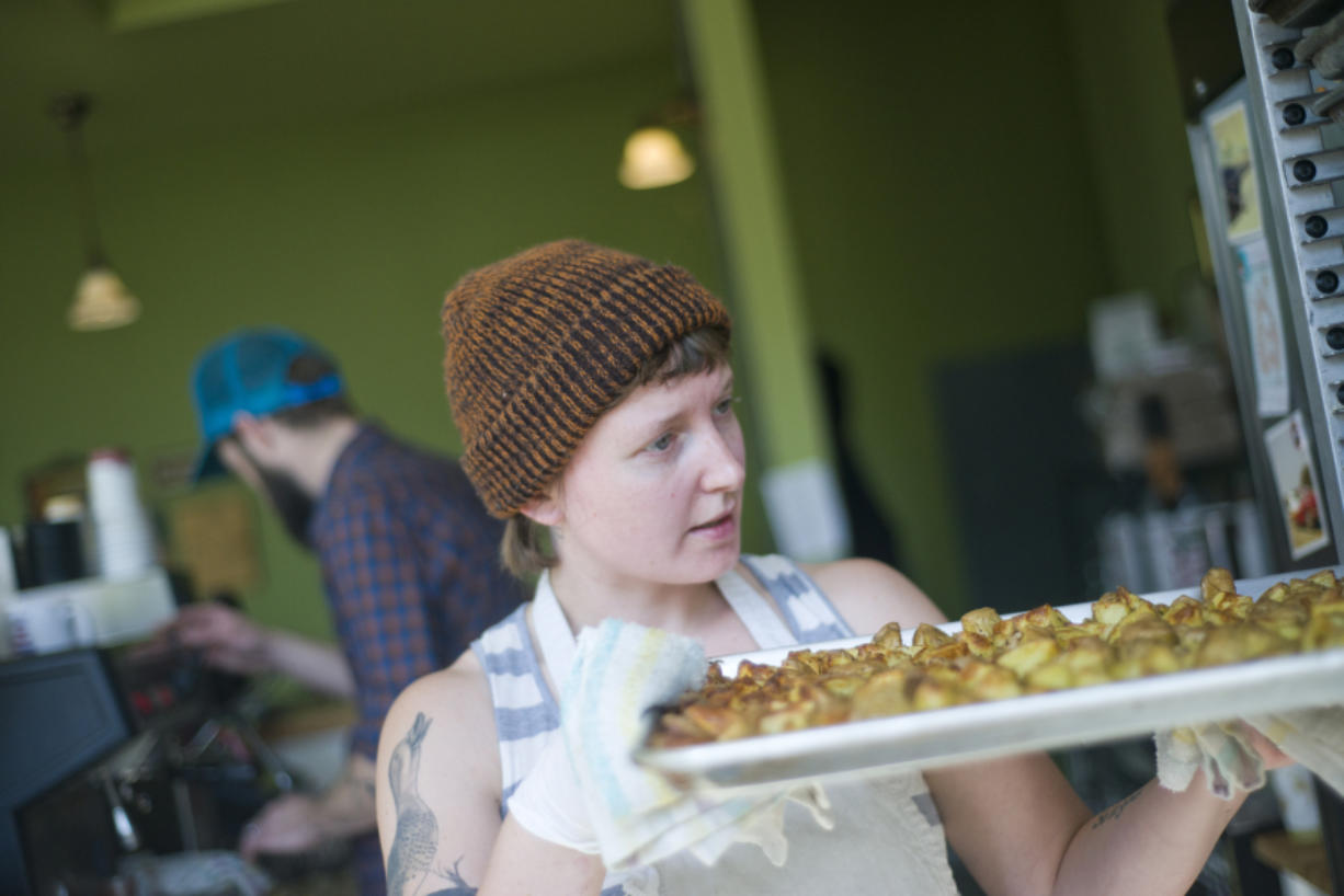 Alex Yost, co-owner of OurBar in Washougal, racks a tray of breakfast potatoes. She said she and her husband were pulled into Washougal's "tractor beam of light" when they decided to move to Portland three-plus years ago.
