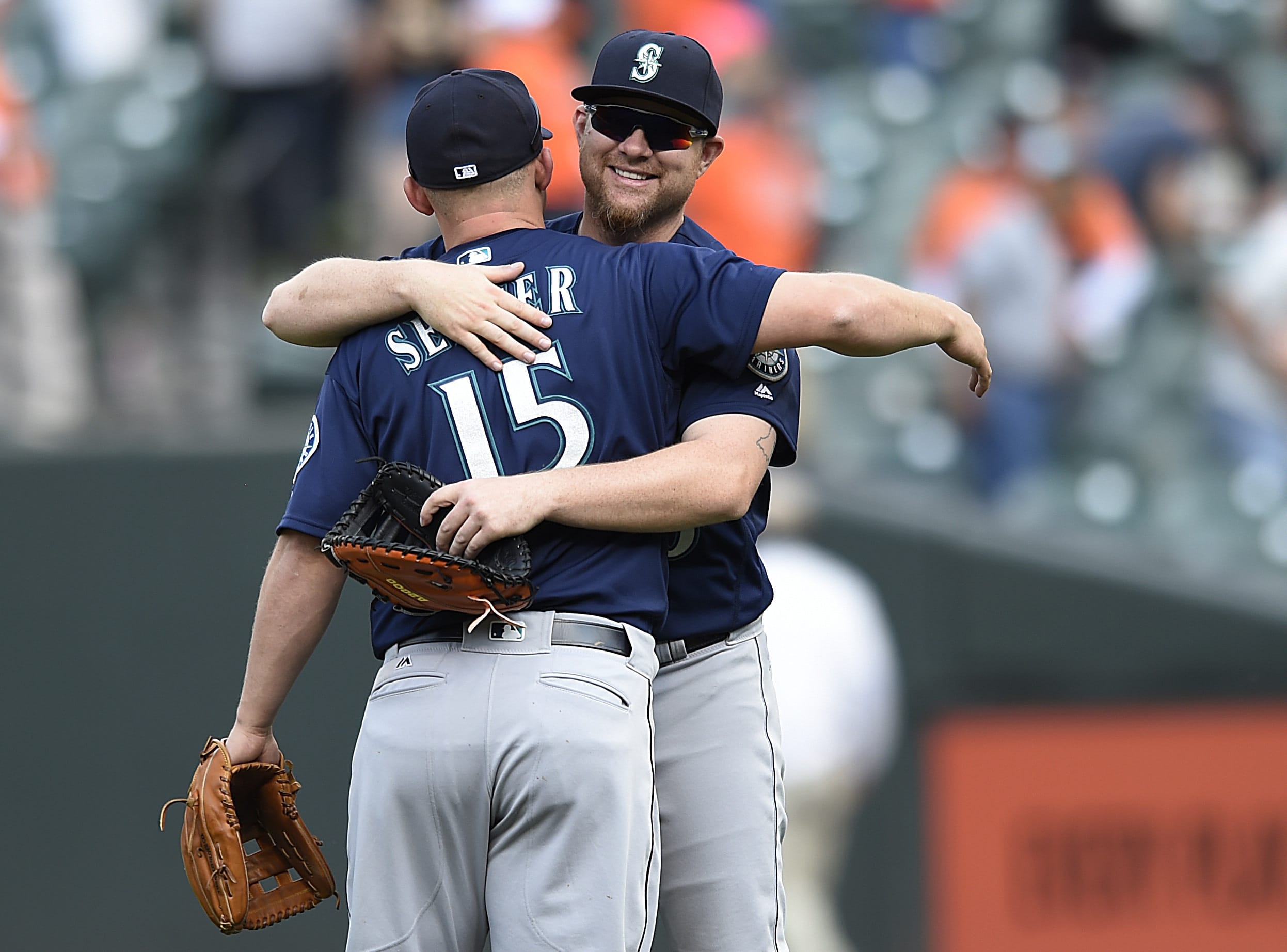 Seattle Mariners, Adam Lind, right, and Kyle Seager celebrate their 7-2 win over the Baltimore Orioles in a baseball game, Thursday, May 19, 2016, in Baltimore.