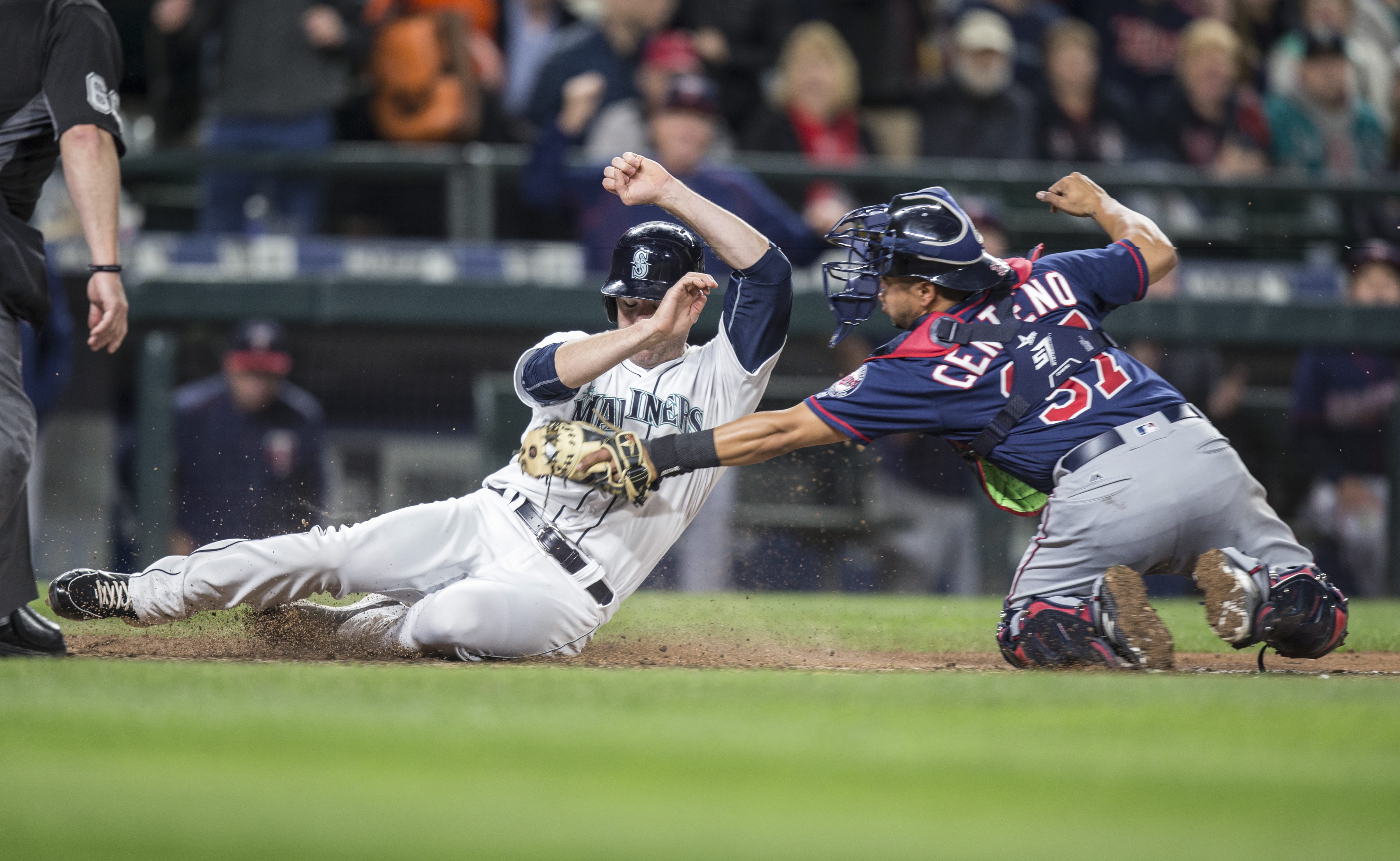 Seattle Mariners' Seth Smith, left, is tagged out at home plate by Minnesota Twins catcher Juan Centeno during the sixth inning of a baseball game  Saturday, May 28, 2016, in Seattle.