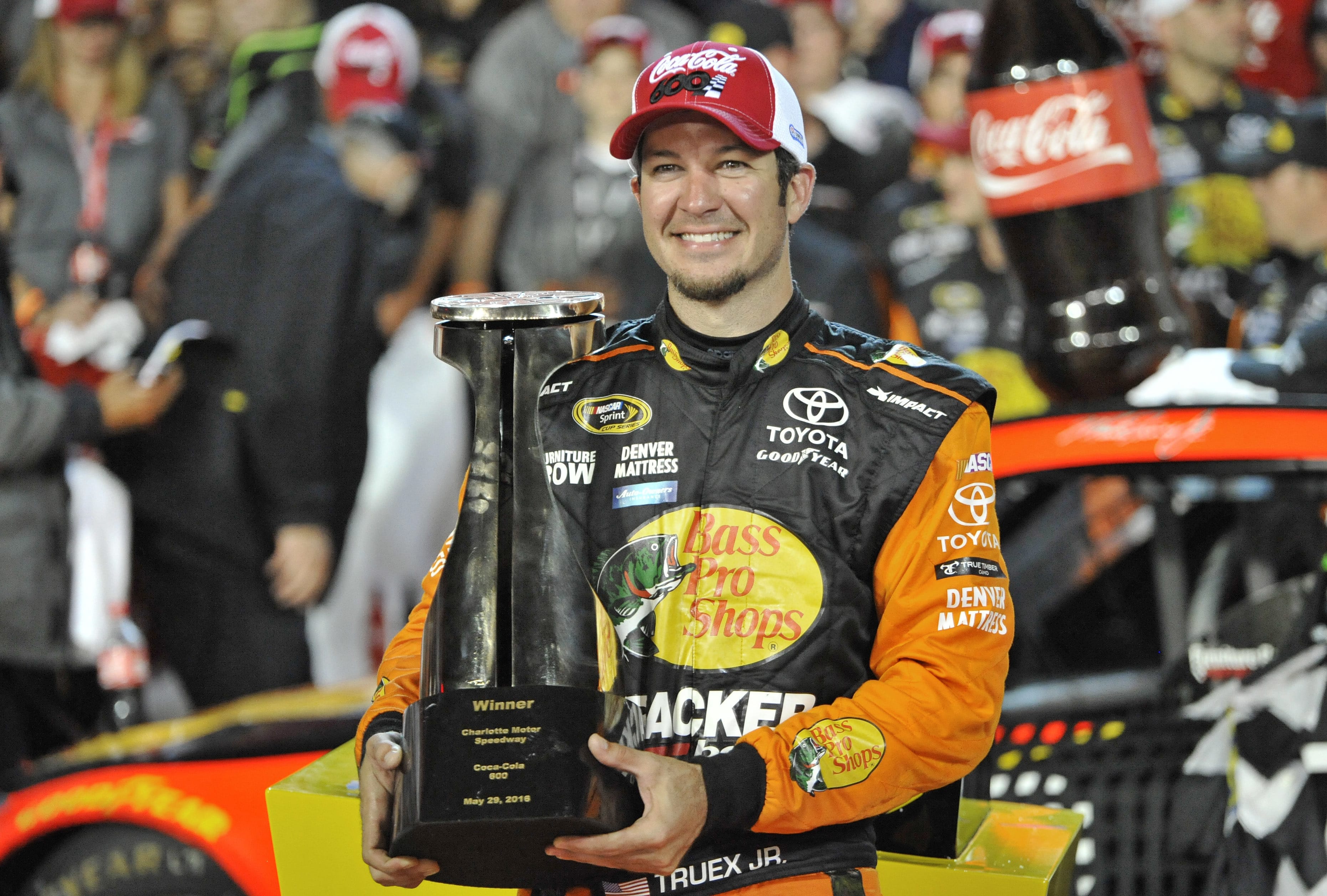 Martin Truex Jr. poses with the trophy after winning the NASCAR Coca-Cola 600 at Charlotte Motor Speedway in Concord, N.C., Sunday, May 29, 2016.