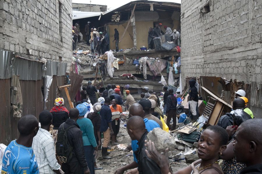 People help survivors retrieve their household items at the site of a building collapse in Nairobi, Kenya, on Saturday.