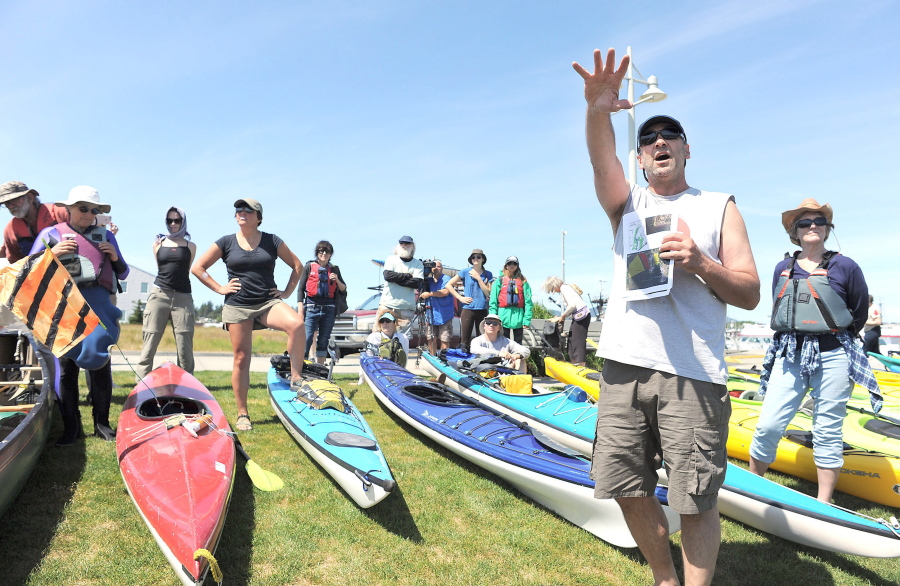 Kayakers listen to a talk on eelgrass and the care that should be taken in not disturbing it near Seafarer&#039;s Memorial Park in Anacortes, Wash., Friday, May 13, 2016. Hundreds of people in kayaks and on foot gathered at the site of two oil refineries in Washington state to call for action on climate change and a fair transition away from fossil fuels.