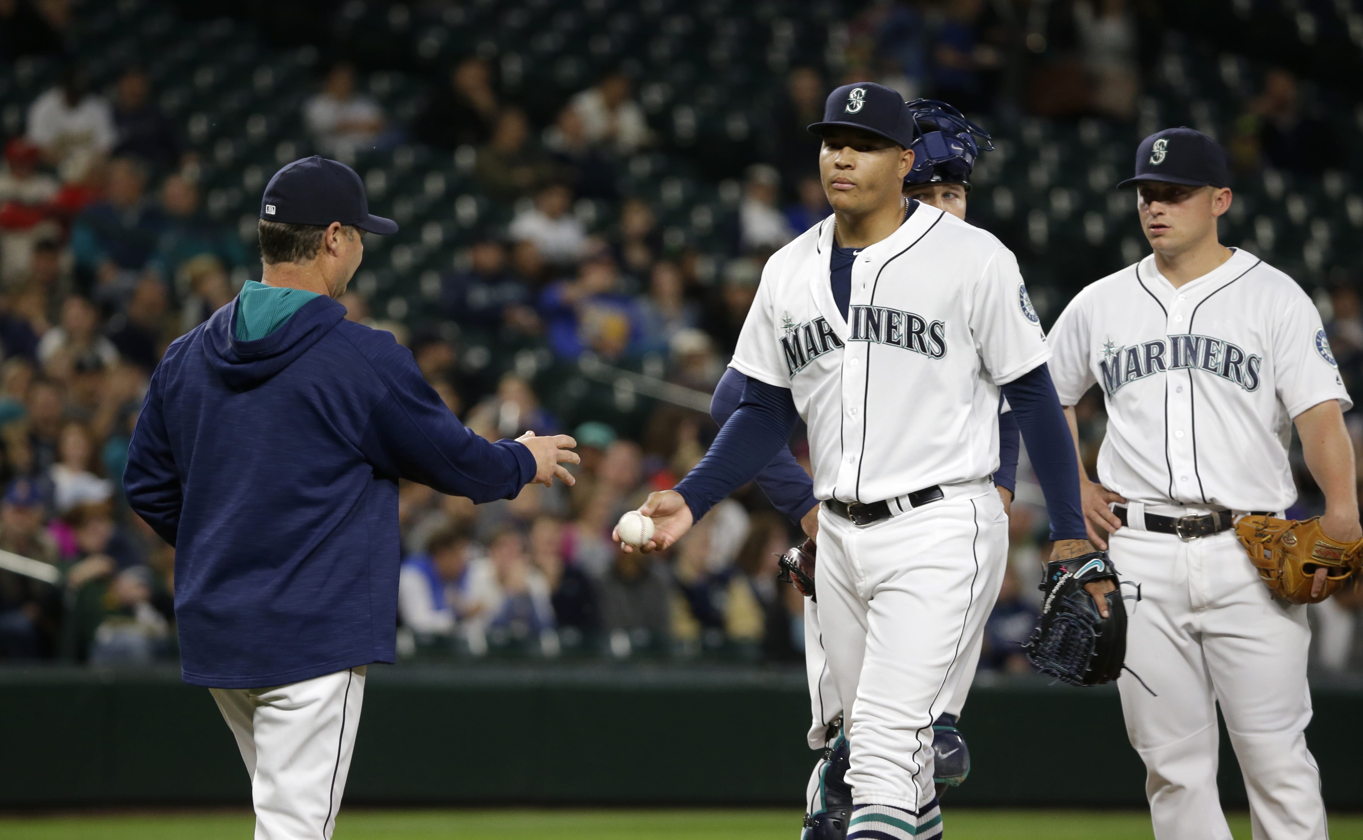 Seattle Mariners starting pitcher Taijuan Walker, second from right, is pulled in the eighth inning of a baseball game against the Oakland Athletics by Mariners manager Scott Servais, left, Monday, May 23, 2016, in Seattle. (AP Photo/Ted S.
