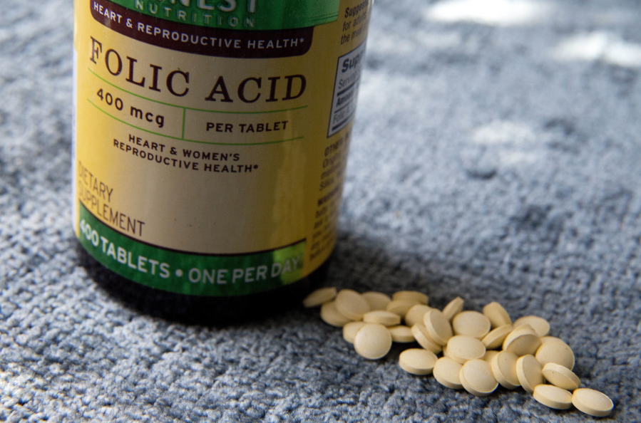 A bottle of folic acid is photographed, Wednesday, May 11, 2016, in New York. A new study suggests very high levels of the vitamin in mothers&#039; blood at the time of childbirth was linked to higher risk of their children developing autism years later. Other research points to an opposite relationship between folic acid and autism, showing that adequate amounts of the vitamin at the time of conception can significantly reduce the risk.