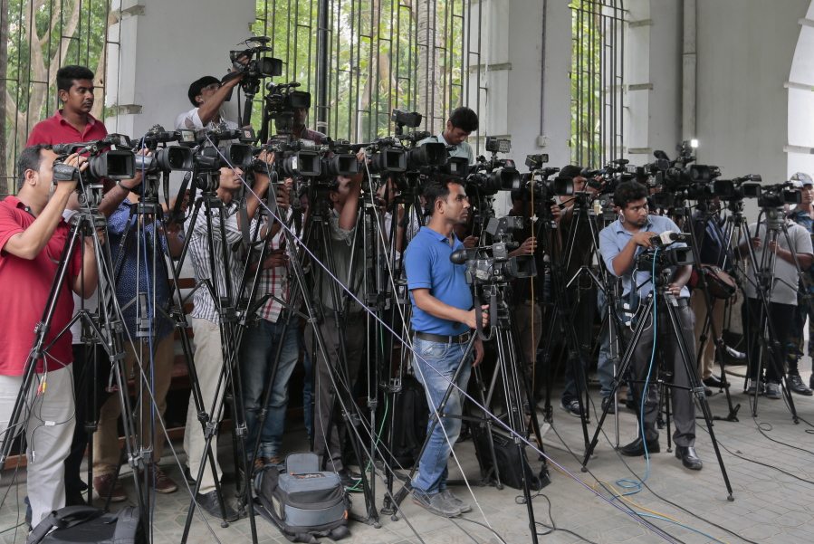Bangladeshi journalists cover proceedings  outside a court in Dhaka, Bangladesh, on Tuesday. Tuesday marks World Press Freedom Day. (AP Photo/ A.M.