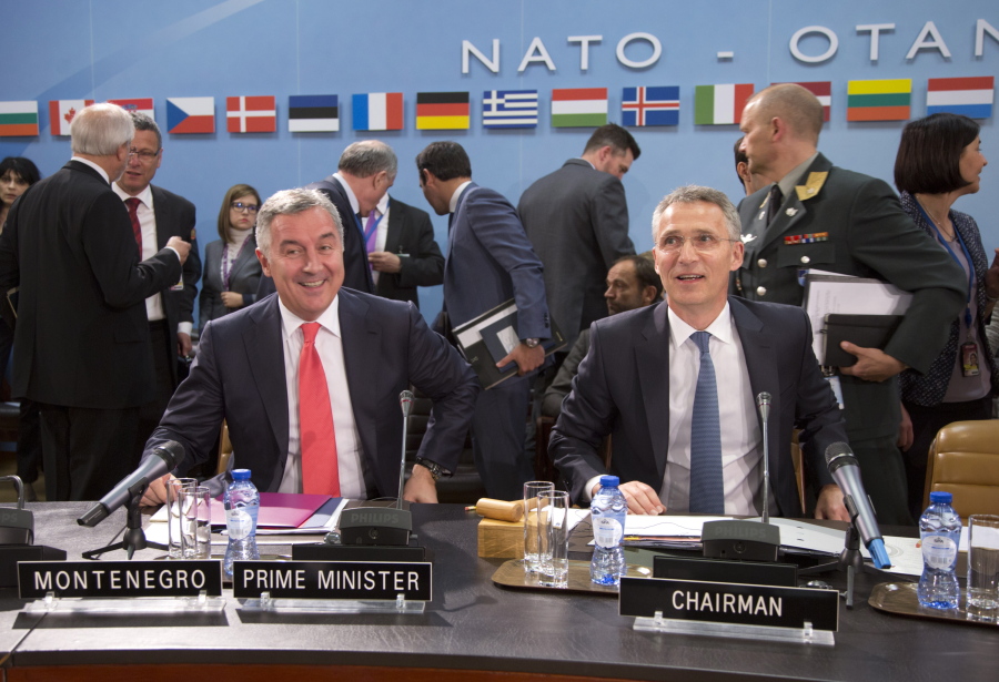 NATO Secretary General Jens Stoltenberg, right, and Montenegro&#039;s Prime Minister Milo Dukanovic, left, take their seats during a meeting of the North Atlantic Council and Montenegro at NATO headquarters in Brussels on Thursday, May 19, 2016. NATO foreign ministers this week will discuss how the alliance can deal more effectively with security threats outside Europe, including by training the Iraqi military and cooperating with the European Union to choke off people-smuggling operations in the central Mediterranean.