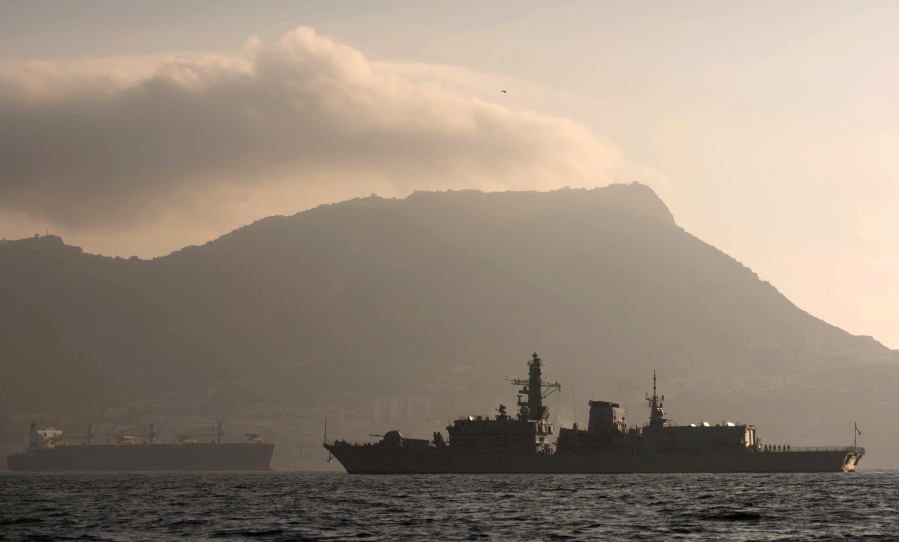 Britain&#039;s Royal Navy ship HMS Westminster, right, sails along the Gibraltar stretch, backdropped by the tiny territory on the southern tip of the Iberian peninsula the rock of Gibraltar, near to La Linea de la Concepcion, Spain.