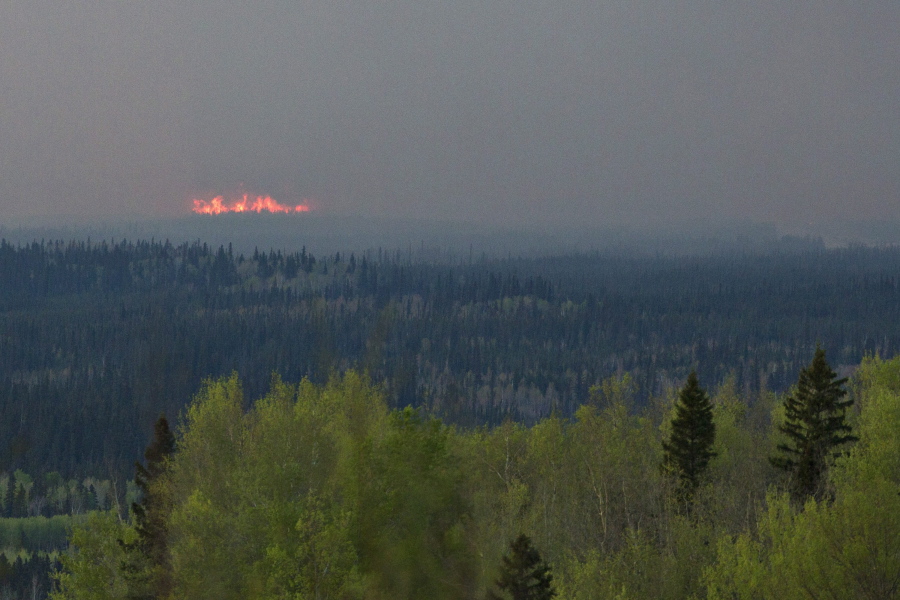 A wildfire flares up near Fort McMurray, Alberta, on Thursday. Canadian officials will start moving thousands of people from work camps north of devastated Fort McMurray in a mass highway convoy Friday morning if it is safe from the wildfire raging in Alberta.