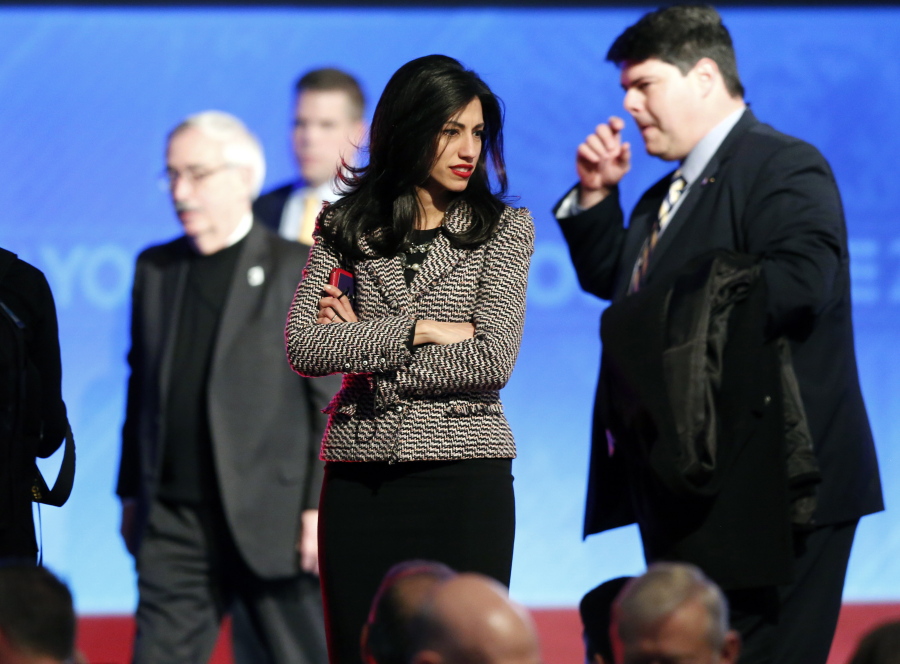 Huma Abedin, center, aide to Hillary Clinton, stands on stage after a Democratic presidential primary debate in Manchester, N.H.
