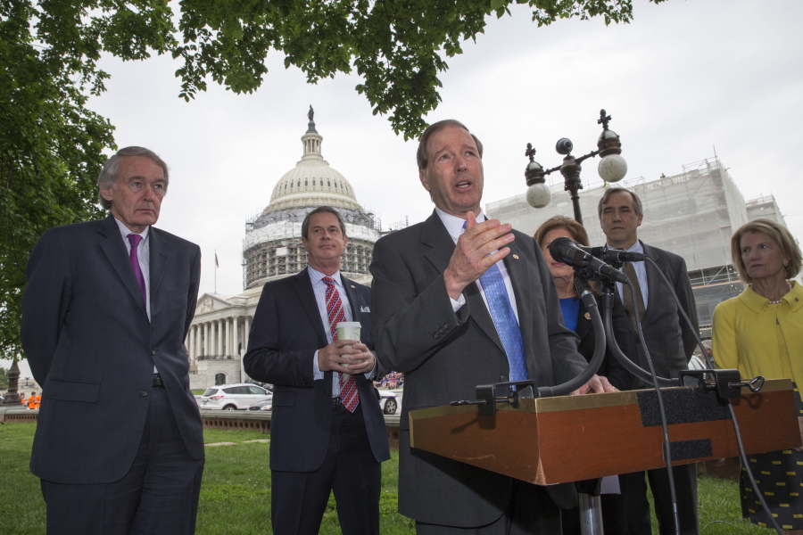 Sen. Tom Udall, D-N.M., center, joined by, from left, Sen. Edward J. Markey, D-Mass., Sen. David Vitter, R-La., Bonnie Lautenberg, widow of the late New Jersey Sen. Frank Lautenberg, Sen. Jeff Merkley, D-Ore., and Sen. Shelley Moore Capito R-W. Va., talks about bipartisan legislation to improve the federal regulation of chemicals and toxic substances Thursday during a news conference on Capitol Hill in Washington. Sen. Udall is the sponsor of the bill which was initiated by Sen. Frank Lautenberg. (AP Photo/J.