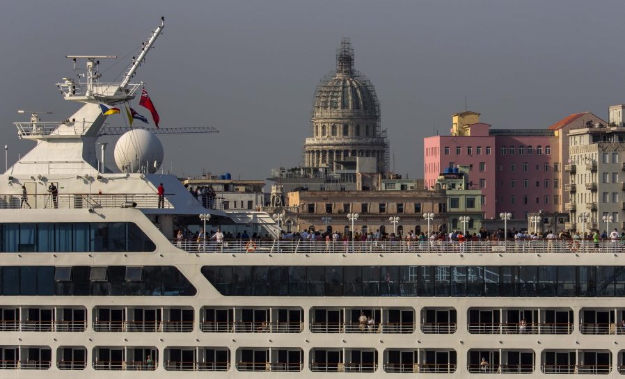 Passengers stand on Carnival&#039;s Adonia cruise ship as they arrive from Miami in Havana, Cuba, on Monday. The Adonia&#039;s arrival is the first step toward a future in which thousands of ships a year could cross the Florida Straits, long closed to most U.S.-Cuba traffic due to tensions that once brought the world to the brink of nuclear war.
