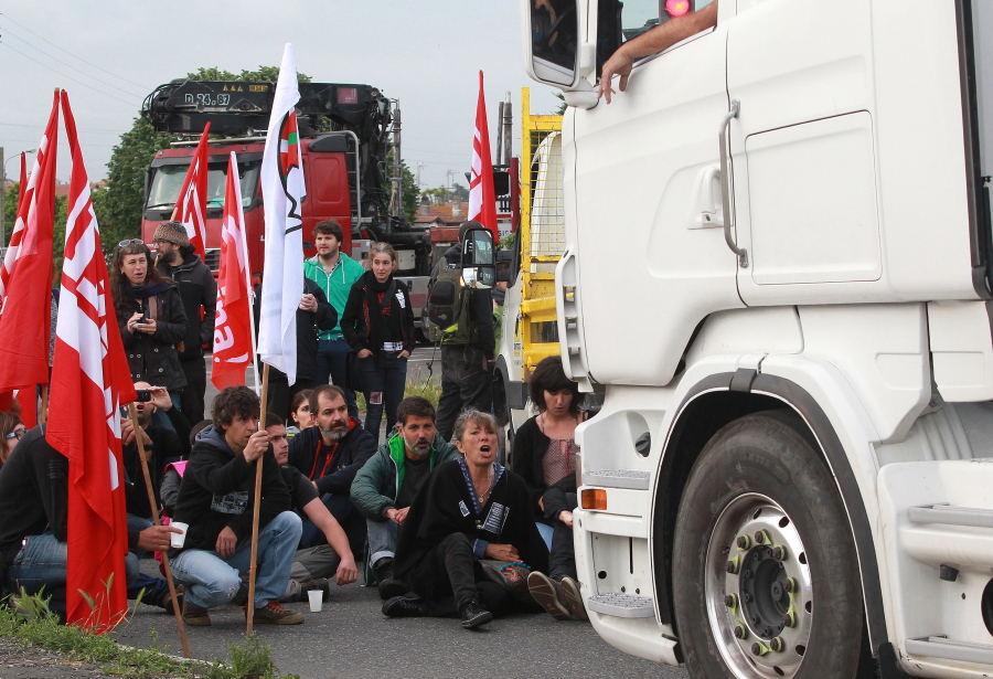 Union activists block the entrance of the industrial area in Boucau, France, on Thursday, a day of nationwide strikes and protests over labor reform.