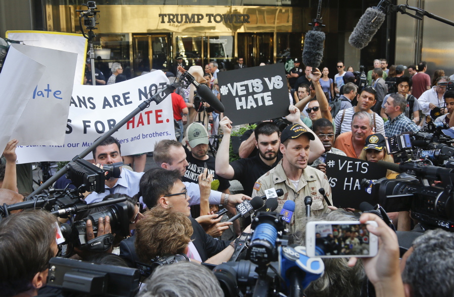 U.S. Army veteran Perry O&#039;Brien, center, holds a press briefing with protesting veterans outside a Donald Trump news conference Tuesday in New York. &quot;I think Donald Trump clearly thinks the veteran community is for sale,&quot; said O&#039;Brien. &quot;We were here last week calling him out on his dishonesty around these [veteran charity] donations.&quot; Following sustained media pressure, Trump announced Tuesday the charities that have received millions of dollars from a veterans fundraiser he held four months earlier.