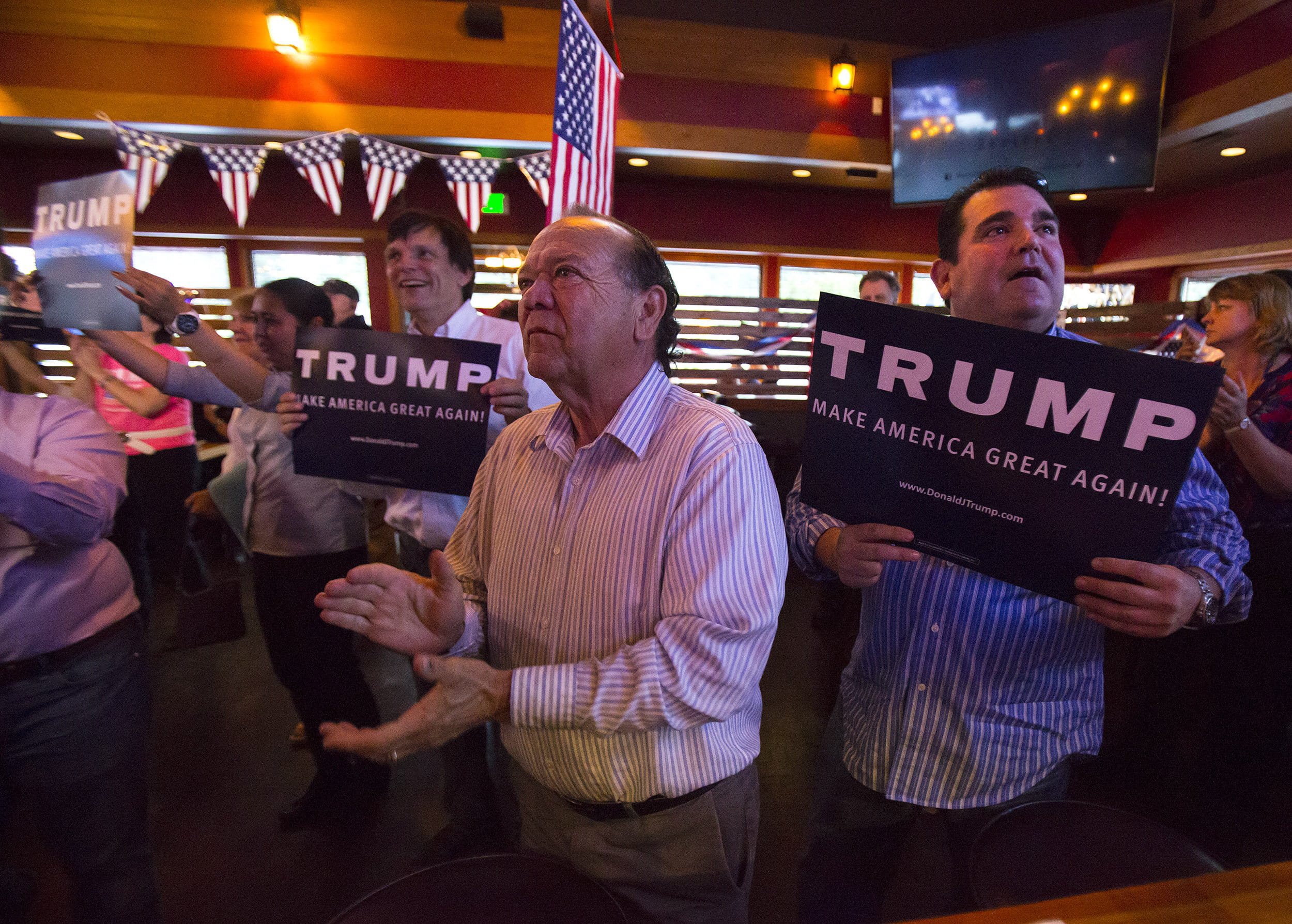 Cle Elum resident Sno Benavides, center, celebrates early Washington primary results showing a wide-margin victory for Republican presidential candidate Donald Trump at Cask and Trotter, Tuesday, May 24, 2016, in Lynwood, Wash.  Standing to the right of Sno is his nephew Chente Benavides.