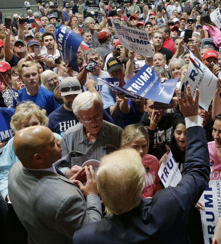 Republican presidential candidate Donald Trump, lower center, greets supporters after a rally in Spokane, Wash., Saturday, May 7, 2016. Trump spent a second day in the Northwest on Saturday, telling supporters he'd win Washington state in November and decrying manufacturing job losses.