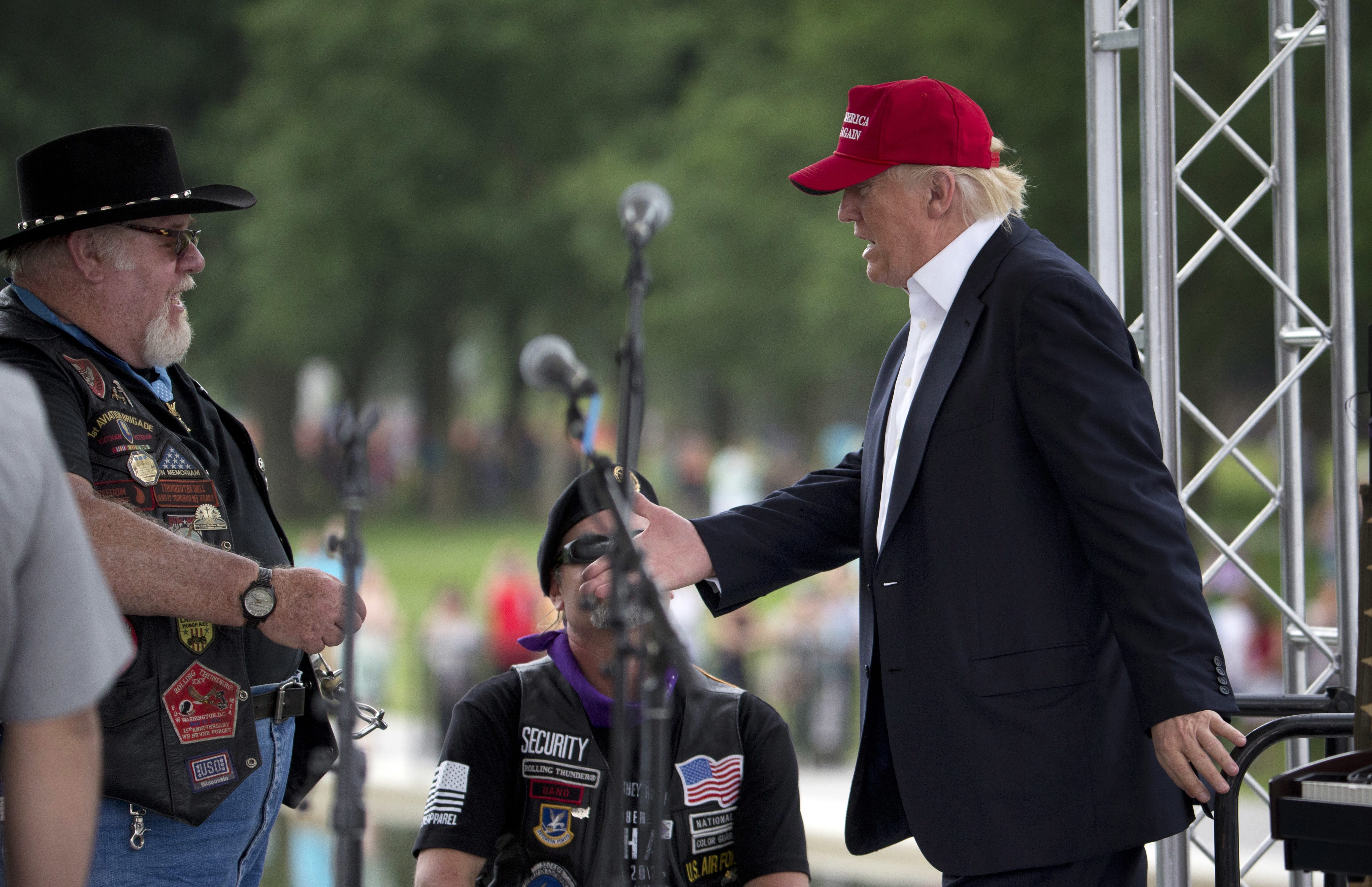 Republican presidential candidate Donald Trump, right, greets supporters and bikers at a Rolling Thunder rally at the National Mall in Washington, Sunday, May 29, 2016.