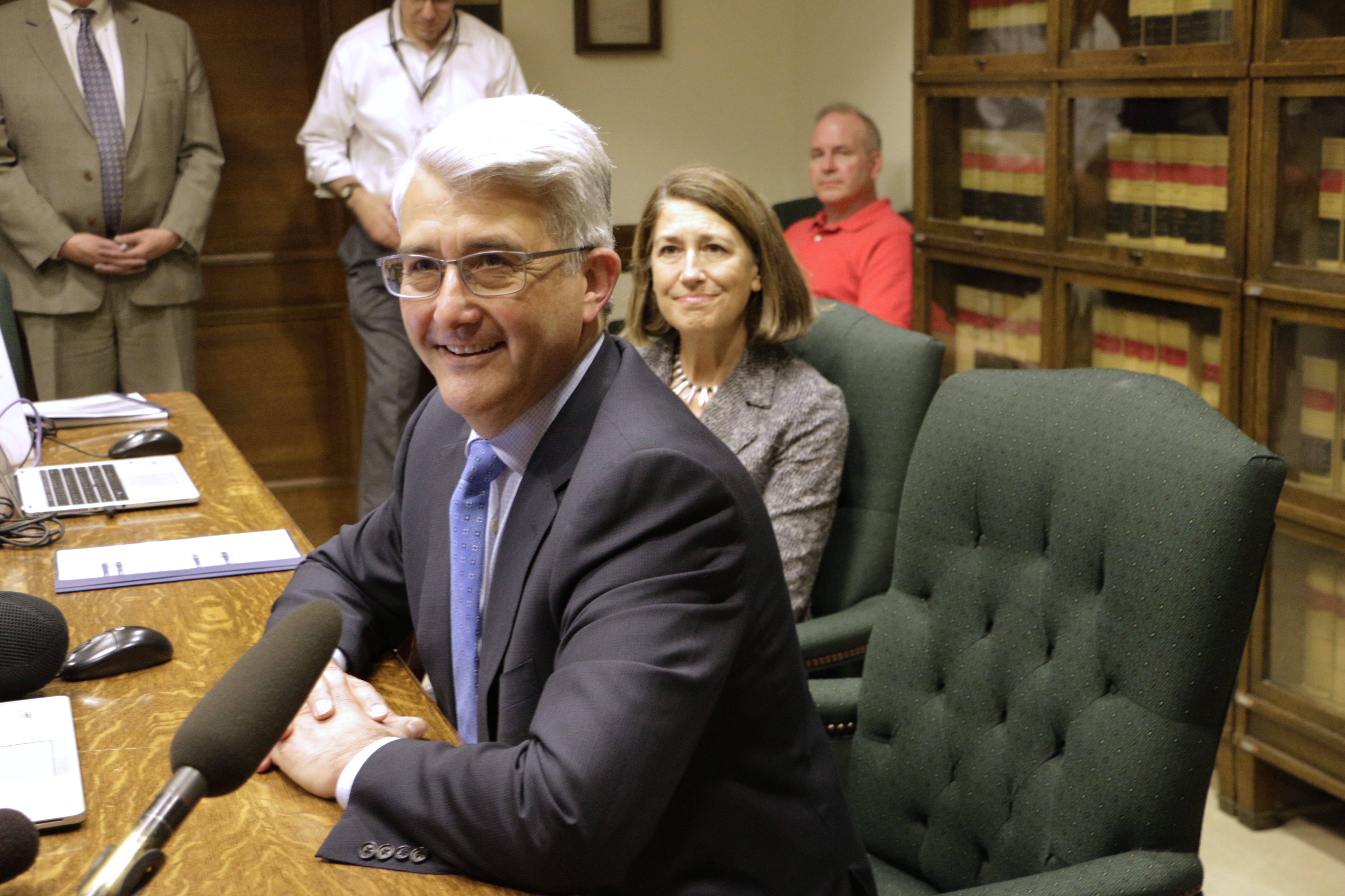 Republican Bill Bryant speaks with the media after filing to run for governor at the Capitol in Olympia, as his wife, Barbara Feasey, looks on Thursday. Bryant is challenging incumbent Democratic Gov. Jay Inslee.