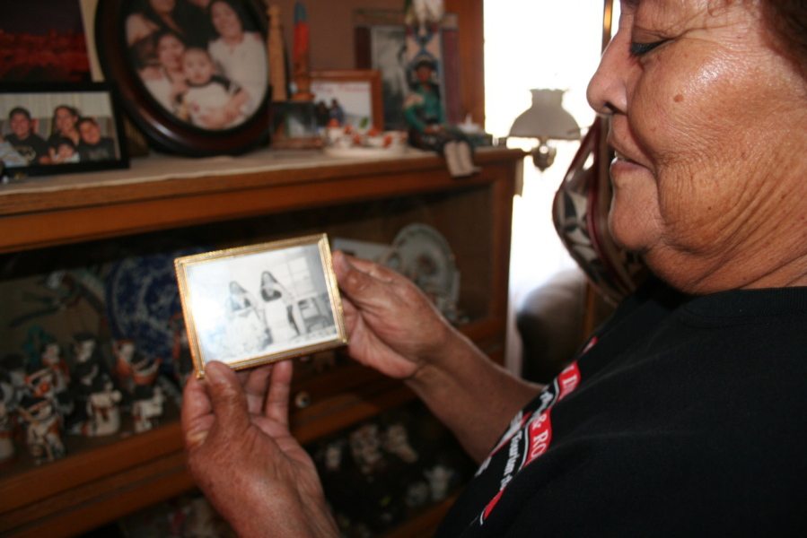Mary Lowden holds a photo of her mother and her aunt, both pottery makers, during a visit to her home at Acoma Pueblo, N.M.