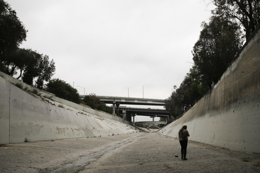 Anthropologist Susan Phillips walks along the Los Angeles River while searching for graffiti by hobos in Los Angeles. Phillips had spent a career examining the graffiti that covers urban walls, bridges and freeway overpasses. But when she came across a heretofore unrecognizable collection made not of spray paint but substances like grease pencil and apparently left there for a century, she was stunned. (AP Photo/Jae C.