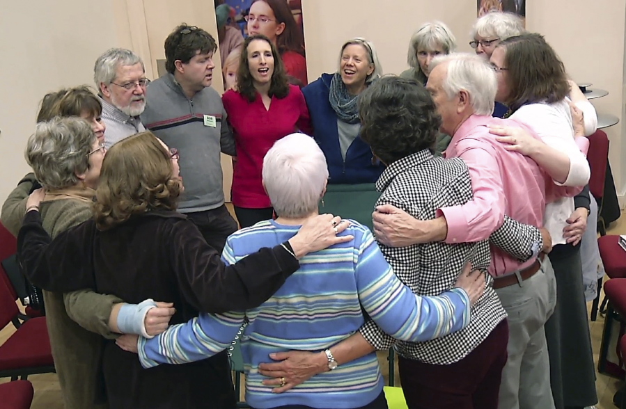In this Feb. 17, 2016 still image from video, members of Threshold Choir gather and singing in Littleton, Mass.  One of a growing number of hospice choirs across the country, the all-volunteer group sings, by invitation only,  at the bedsides of the elderly and terminally ill in hospitals, nursing homes and private residences.