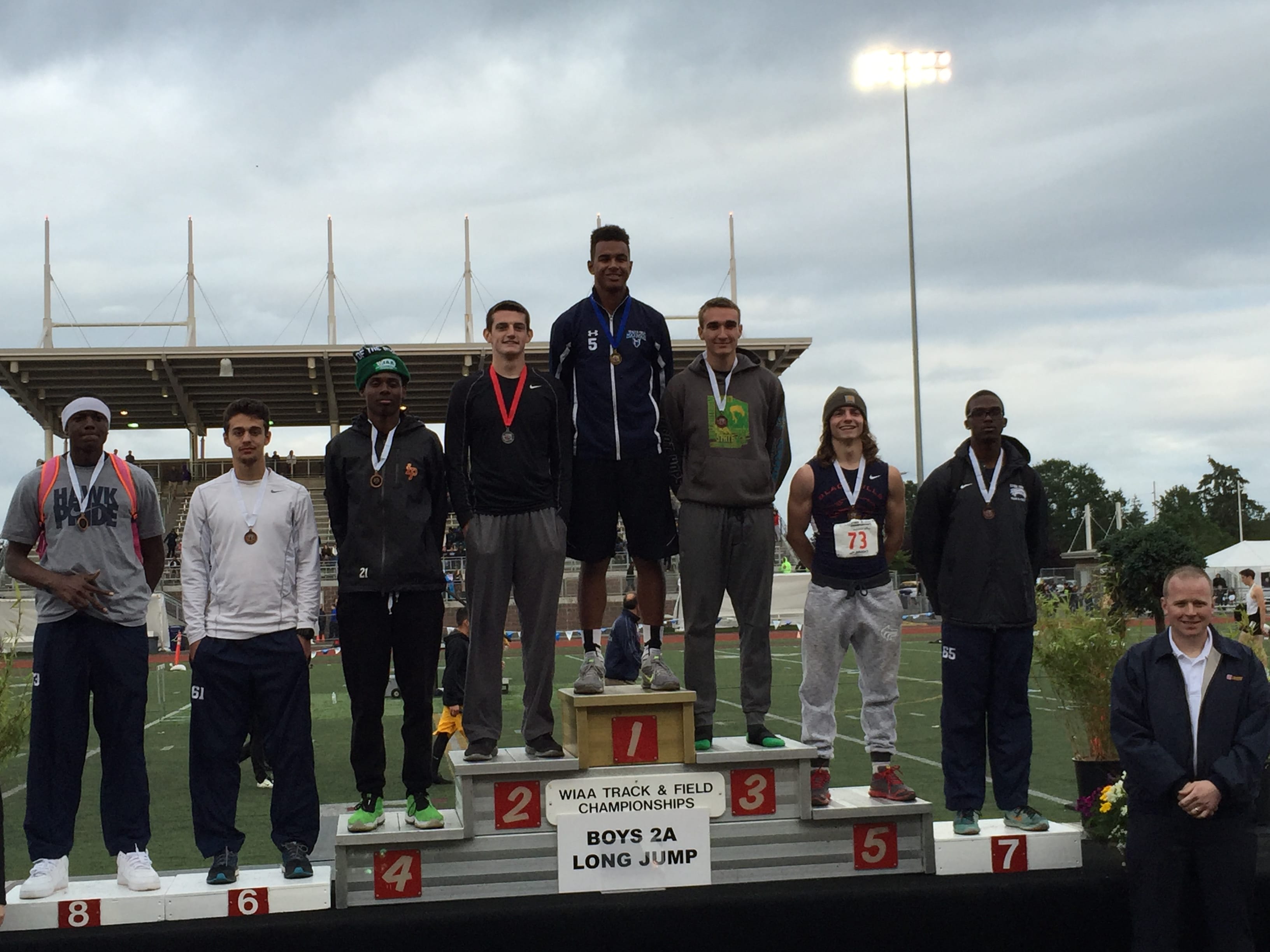Hockinson senior Kedrick Johnson stands atop the podium after winning the Class 2A long jump at the state track and field meet Thursday in Tacoma.