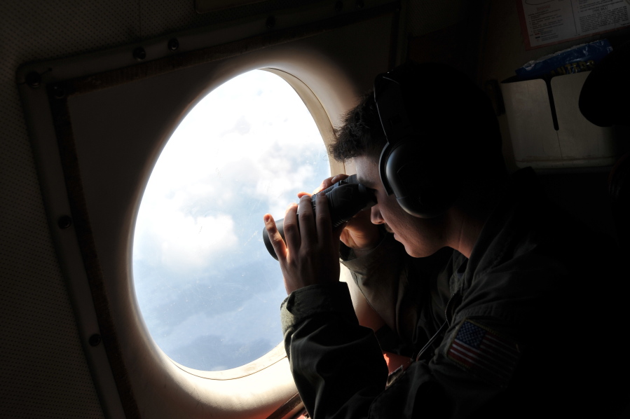U.S. Navy LT. JG Dylon Porlas uses binoculars to look through the window of a U.S. Navy Lockheed P-3C Orion patrol aircraft from Sigonella, Sicily, on Sunday searching the area in the Mediterranean Sea where the Egyptair flight 804 en route from Paris to Cairo went missing on May 19. Search crews found floating human remains, luggage and seats from the doomed EgyptAir jetliner Friday but face a potentially more complex task in locating bigger pieces of wreckage and the black boxes vital to determining why the plane plunged into the Mediterranean.