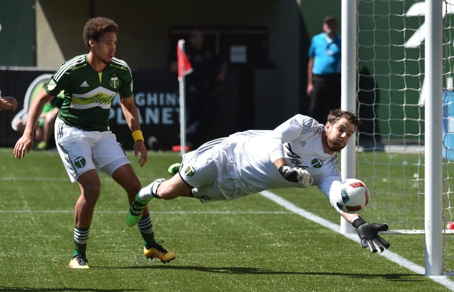 Portland Timbers goalkeeper Jake Gleeson makes a save as defender Chris Klute looks on during the second half of an MLS soccer game against Toronto FC in Portland, Ore., Sunday, May 1, 2016. The Timbers won 2-1.
