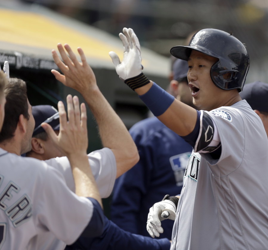 Seattle Mariners&#039; Dae-Ho Lee, right, is congratulated after hitting a two run home run off Oakland Athletics&#039; John Axford in the seventh inning of a baseball game Wednesday, May 4, 2016, in Oakland, Calif.
