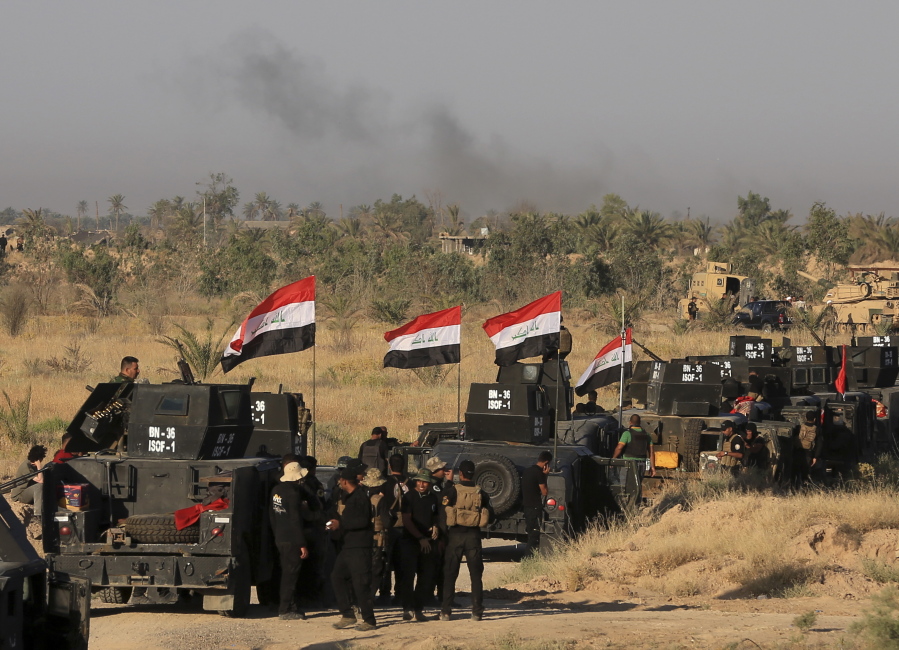Smoke billows on the horizon Monday as Iraqi military forces prepare for an offensive into Fallujah to retake the city from Islamic State militants in Iraq.