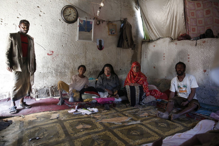 A family from a community who call themselves the &quot;Muhammasheen,&quot; or &quot;the Marginalized,&quot; who fled the city of Taiz due to the ongoing civil war, pose for a photo inside their home in a slum area of Sanaa, Yemen.