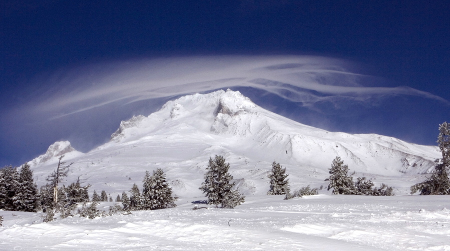 A cloud forms over Mount Hood as seen from Government Camp, Ore.