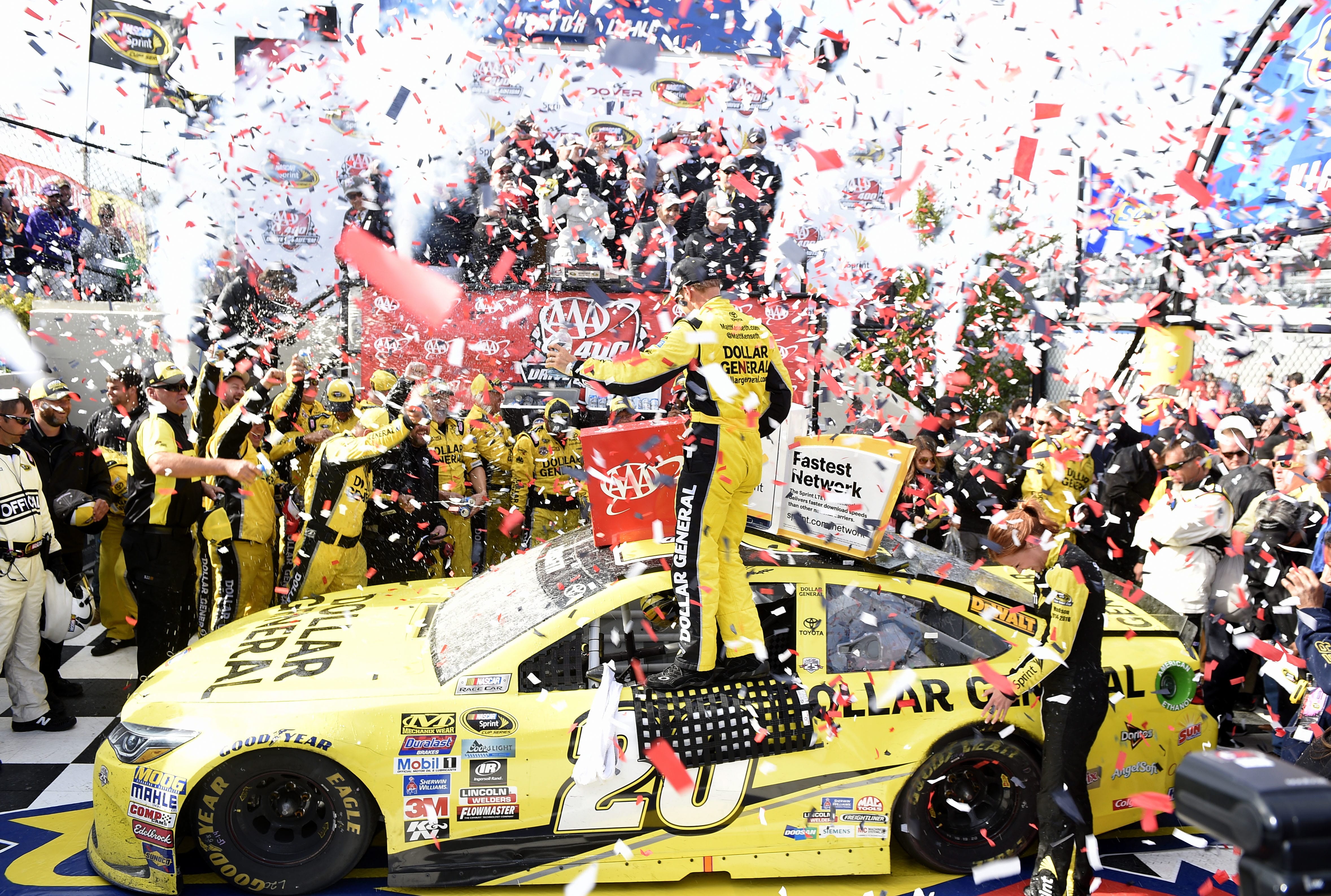 Matt Kenseth, center, celebrates in Victory Lane after he won the NASCAR Sprint Cup series auto race, Sunday, May 15, 2016, at Dover International Speedway in Dover, Del.