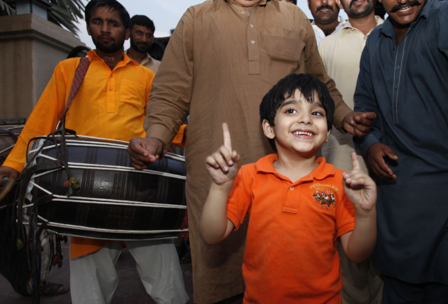 Jamal Uddin, 6, celebrates the release of his father Ali Haider Gilani in Lahore, Pakistan, on Tuesday. A joint raid by U.S. and Afghan forces on Tuesday rescued the son of a former Pakistani prime minister who was held captive for three years by Islamic militants, officials said. Gilani was found during the raid near Afghanistan&#039;s eastern border with Pakistan, according to a spokesman for Afghan President Ashraf Ghani. (AP Photo/K.M.