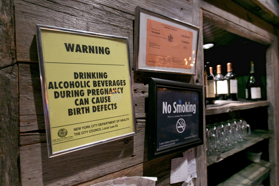 The drinking and pregnancy warning notice is posted behind the bar at the Route 66 Smokehouse, in New York&#039;s Financial District, Friday, May 6, 2016. Pregnant women can&#039;t be barred from New York City bars or refused alcoholic drinks just because they&#039;re expecting, under new official guidance on a city rights law. Human Rights Commission officials say they&#039;re not saying that expectant mothers should drink, but that such health decisions are up to the woman, not a bartender.