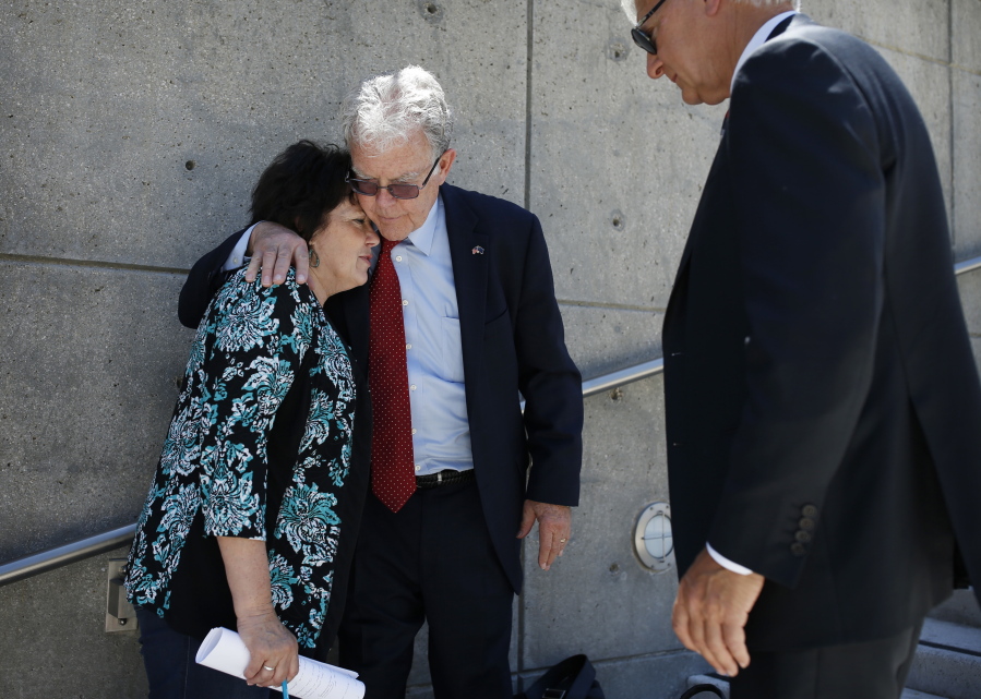 Carol Bundy, left, wife of Nevada rancher Cliven Bundy, speaks with Joel Hansen, center, attorney for Cliven Bundy, and Larry Klayman outside of the federal courthouse  May 10 in Las Vegas.