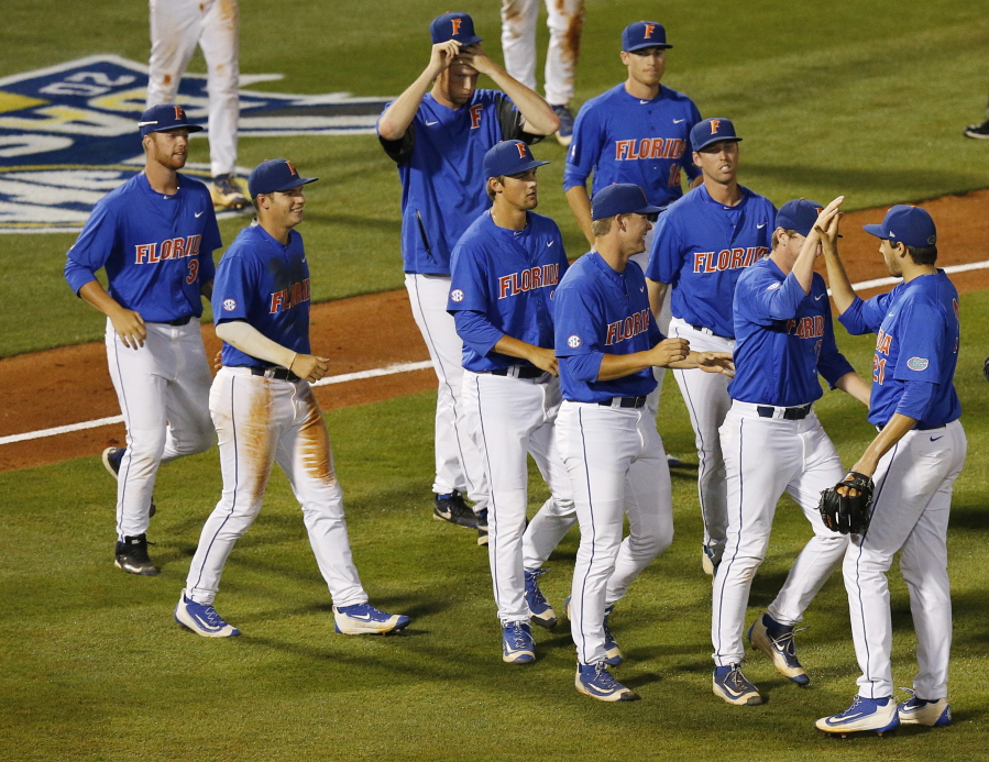Florida pitcher Alex Faedo, far right, celebrates with his team after winning  a Southeastern Conference NCAA college baseball tournament game against Mississippi State, Friday, May 27, 2016, in Hoover, Ala.
