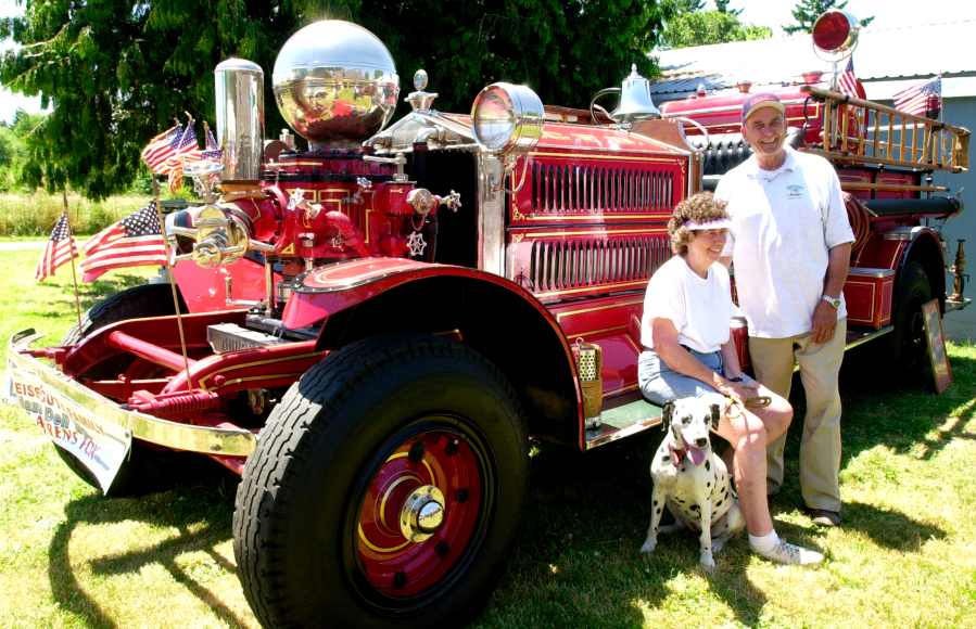 Marilyn and Dick Streissguth of Hazel Dell, with their dog Maggie, and a 1927 Ahrens-Fox fire engine.